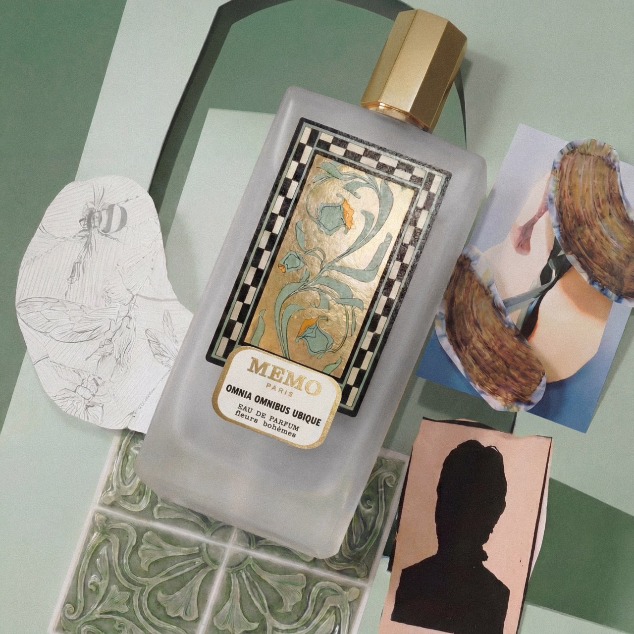 Omnia Omnibus Ubique eau de parfum on a green mood board of sketches and glazed tiles