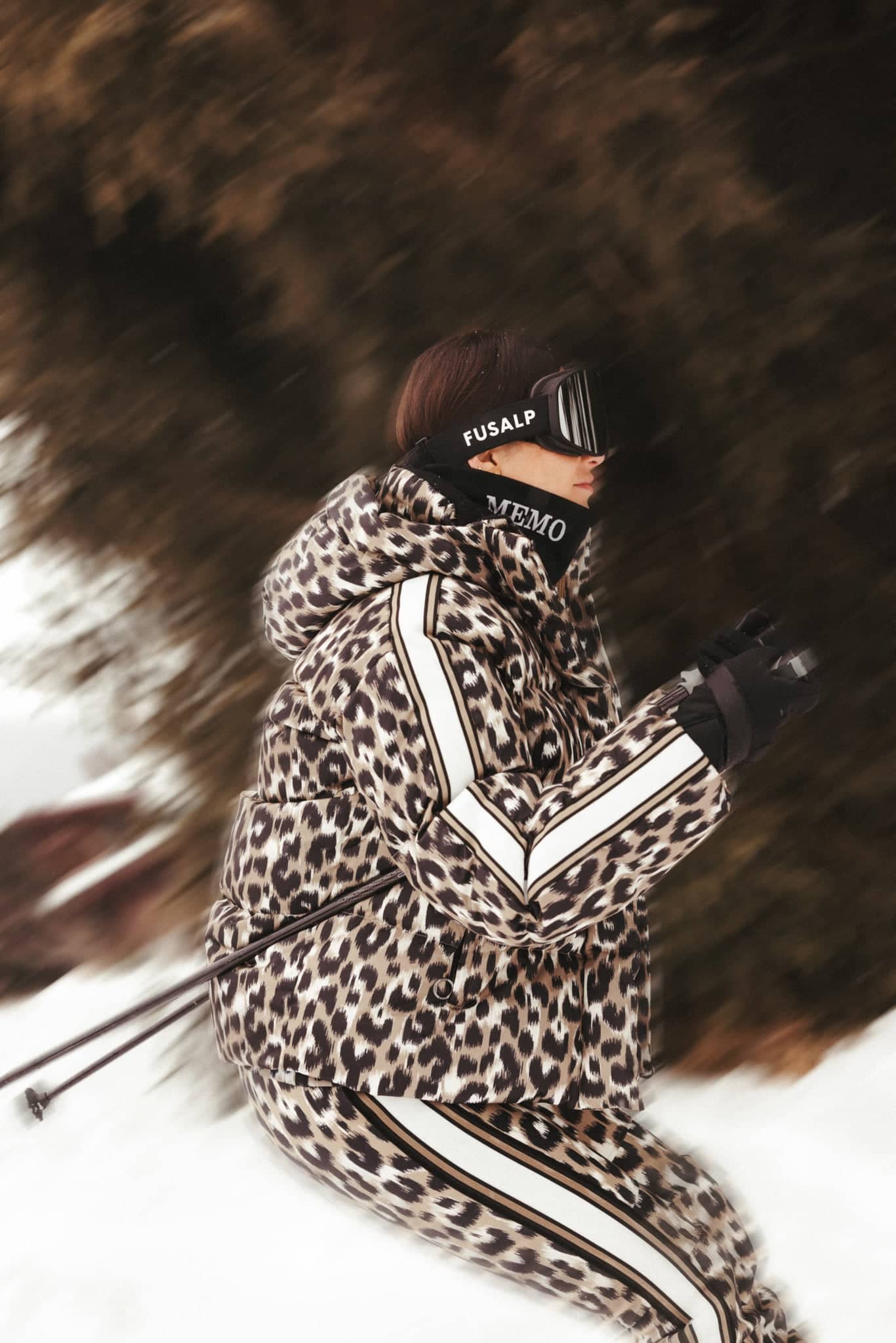 Leopard-print puffer ski suit with white stripe accents.