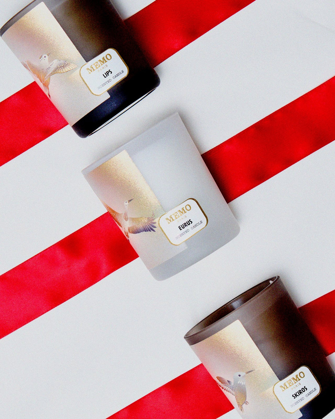 Lips, Eurus and Boreas scented candles on red stripes
